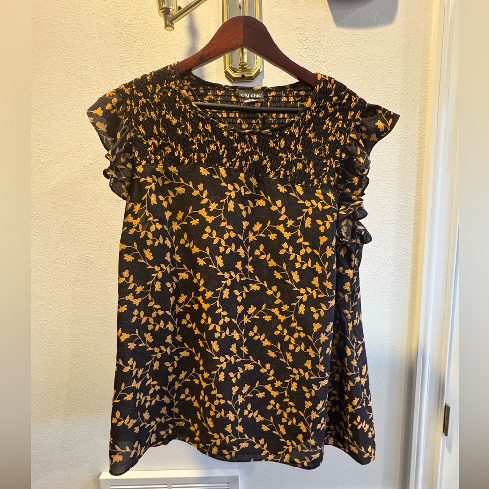 City Chic Blouse
Size S (16)
Black with floral design in mustard 
Ruffled sleeve